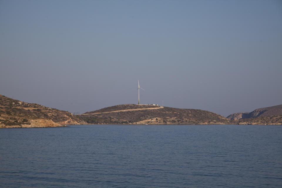 In this photo dated Thursday, Aug. 9, 2018, a wind turbine on the Aegean island of Tilos, Greece. Tilos with its winter population of 400 and summer population of some 3000, stands on the brink of becoming the first island in the Mediterranean to run exclusively on wind and solar power when the blades of the 800 kilowatt wind turbine start turning. (AP Photo/ Iliana Mier)