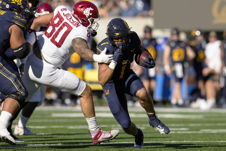 California running back Jaydn Ott (1) gets past Washington State defensive end Brennan Jackson (80) during the first half of an NCAA college football game Saturday, Nov. 11, 2023, in Berkeley, Calif. (AP Photo/Godofredo A. Vásquez)