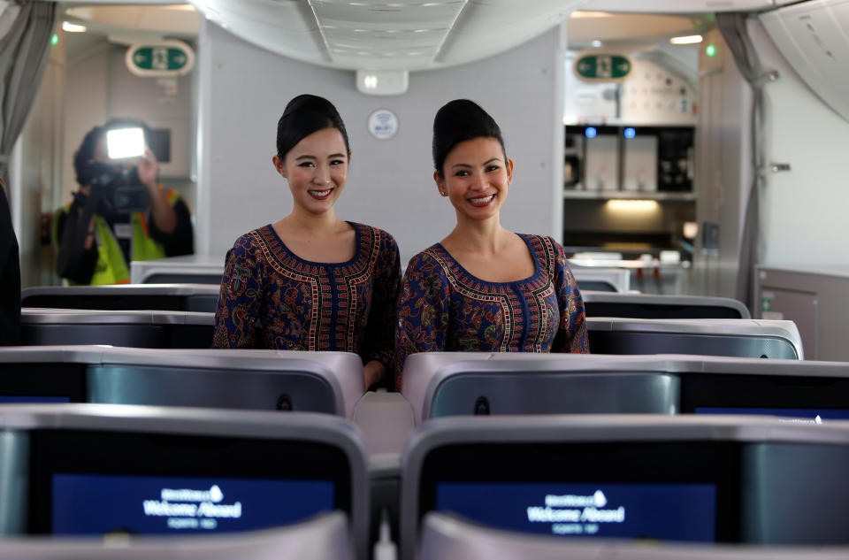Singapore Airlines stewardesses Karie Choo (L) and Joslyn Hue pose for photos in the business class section of the 787-10 Dreamliner after a delivery ceremony at the Boeing South Carolina plant in North Charleston, South Carolina, U.S., March 26, 2018. Picture taken March 26, 2018. REUTERS/Randall Hill
