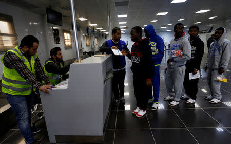 Guinean migrants wait to receive documents at the airport before they are deported to Guinea, in Misrata, Libya, December 27, 2017. REUTERS/Ismail Zitouny