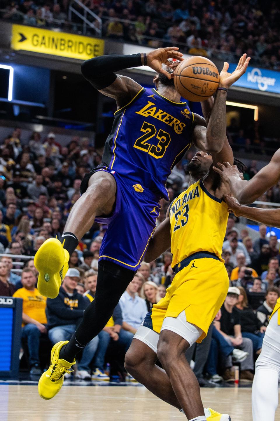 Mar 29, 2024; Indianapolis, Indiana, USA;Los Angeles Lakers forward LeBron James (23) shoots the ball while Indiana Pacers forward Aaron Nesmith (23) defends in the second half at Gainbridge Fieldhouse. Mandatory Credit: Trevor Ruszkowski-USA TODAY Sports
