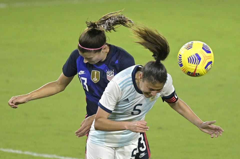 United States forward Alex Morgan (13) and Argentina midfielder Vanesa Santana (5) compete for a header during the second half of a SheBelieves Cup women's soccer match, Wednesday, Feb. 24, 2021, in Orlando, Fla. (AP Photo/Phelan M. Ebenhack)