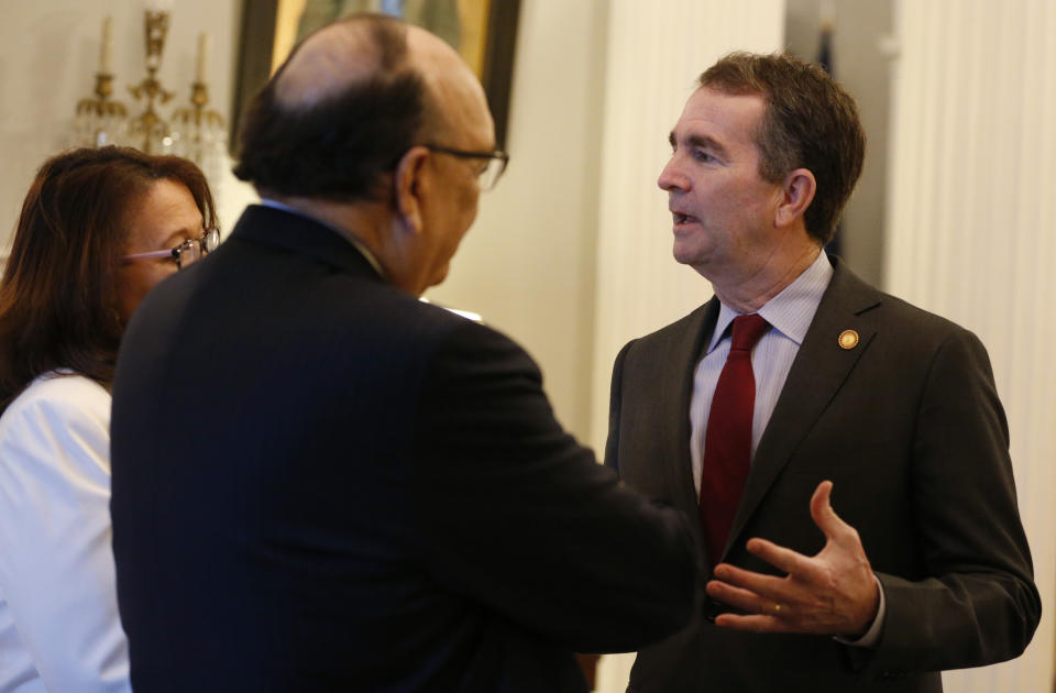 Virginia Gov. Ralph Northam, right, talks with former Virginia Union University president, Rev. Claude Perkins, center, and his wife, Cheryl, left, for a breakfast for the Richmond 34 at the Governors Mansion at the Capitol in Richmond, Va., Friday, Feb. 22, 2019. The breakfast was for The Richmond 34 were a group of African Americans who defied segregation laws in the 1960's (AP Photo/Steve Helber)