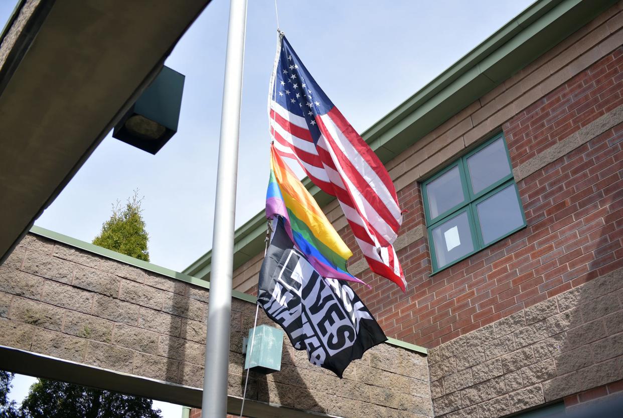 The American flag, a pride flag and a Black Lives Matter flag in the courtyard of the Nativity School in Worcester.