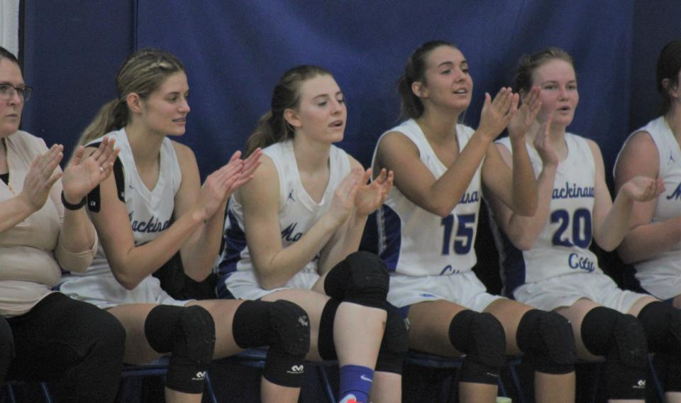 Mackinaw City starters Madison Smith, Larissa Huffman, Marlie Postula and Gracie Beauchamp celebrate from the bench after a made basket during the third quarter on Tuesday.