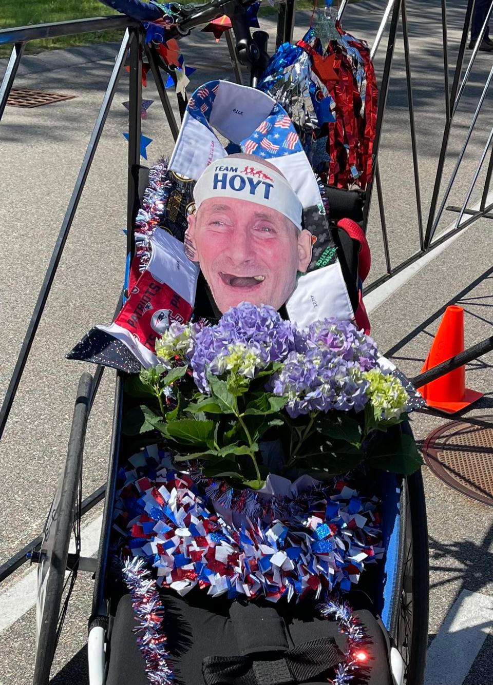 A likeness of Rick Hoyt with a bouquet of hydrangeas was posted in a racing chair at the finish line of Saturday's Dick Hoyt Memorial Yes You Can road race in Hopkinton. Rick died on May 22.