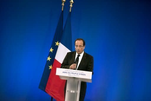 French President Francois Hollande delivers a speech during a meeting of the "Friends of the Syrian People" in Paris. International leaders Friday urged the UN to ratchet up pressure on Syrian President Bashar al-Assad by threatening his regime with tough sanctions, as the defection of a top general rocked his inner circle