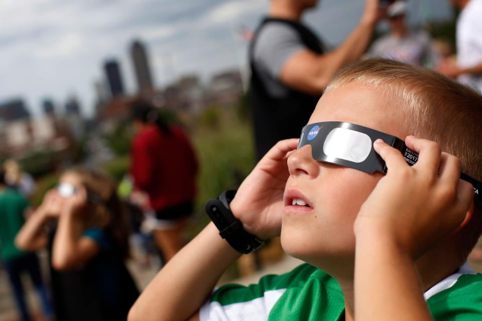 Kellen Hove, 9, of West Des Moines looks to the sky Monday, Aug. 21, 2017, during a solar eclipse watch party outside the Iowa State Capitol in Des Moines.