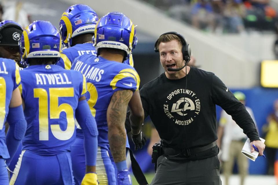 Los Angeles Rams head coach Sean McVay celebrates with players after a touchdown by running back Cam Akers