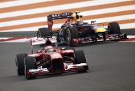 Ferrari Formula One driver Fernando Alonso of Spain (front) drives ahead of Red Bull Formula One driver Mark Webber of Australia during the second practice session of the Indian F1 Grand Prix at the Buddh International Circuit in Greater Noida, on the outskirts of New Delhi, October 25, 2013. REUTERS/Anindito Mukherjee (INDIA - Tags: SPORT MOTORSPORT F1)