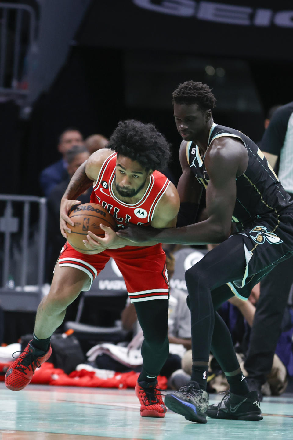 Chicago Bulls guard Coby White, left, competes against Charlotte Hornets forward JT Thor for possession of the ball during the first half of an NBA basketball game in Charlotte, N.C., Thursday, Jan. 26, 2023. (AP Photo/Nell Redmond)