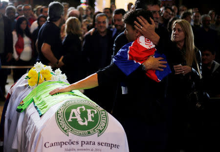 Relatives of Chapecoense soccer club head coach Caio Junior, who died in the plane crash in Colombia, participate in a ceremony to pay tribute to him in Curitiba, Brazil, December 4, 2016. REUTERS/Rodolfo Buhrer
