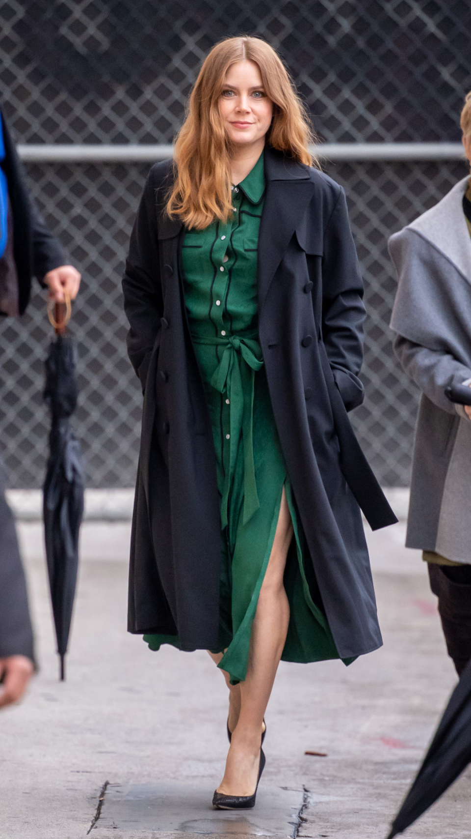 <p> A trench coat can make an ideal stylish cover-up for in-between temperatures. Adams wore the classic outerwear in a chic navy shade, over an emerald green shirt dress, to visit the Los Angeles studios of Jimmy Kimmel Live in 2019.  </p>