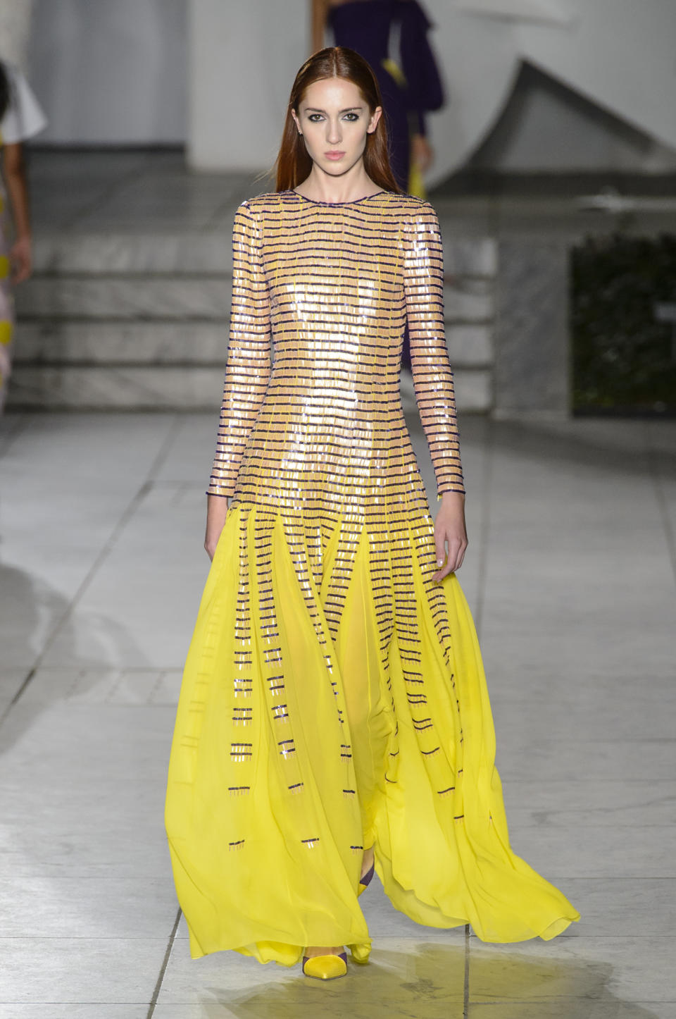 <p><i>A model wears a long-sleeved yellow embellished dress from the SS18 Carolina Herrera collection. (Photo: ImaxTree) </i></p>