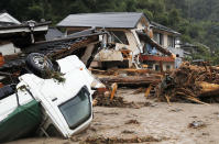 <p>A man stands amid debris caused by a swollen river in Asakura, Fukuoka prefecture, southwestern Japan Thursday, July 6, 2017. Heavy rain following a recent typhoon flooded many houses in southwestern Japan, forcing thousands of people to flee, authorities said. (Photo: Takuto Kaneko/Kyodo News via AP) </p>