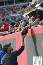 A Tampa Bay Buccaneers fan gives quarterback Tom Brady's 600th career touchdown pass back after wide receiver Mike Evans threw the ball to the fan during the first half of an NFL football game against the Chicago Bears Sunday, Oct. 24, 2021, in Tampa, Fla. (AP Photo/Jason Behnken)