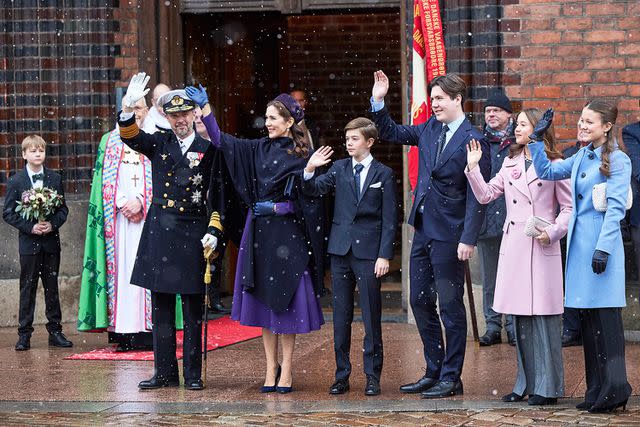 <p>MIKKEL BERG PEDERSEN/Ritzau Scanpix/AFP/Getty</p> King Frederik X, Queen Mary, Prince Vincent, Crown Prince Christian, Princess Isabella and Princess Josephine greet the crowd after a church service at Aarhus Cathedral on Jan. 21.