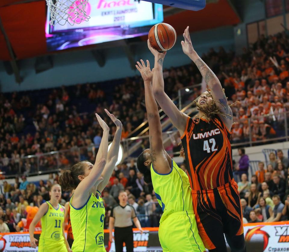Brittney Griner (right) takes a shot in front of a large crowd at UMMC Ekaterinburg's Palace of Sporting Games.
