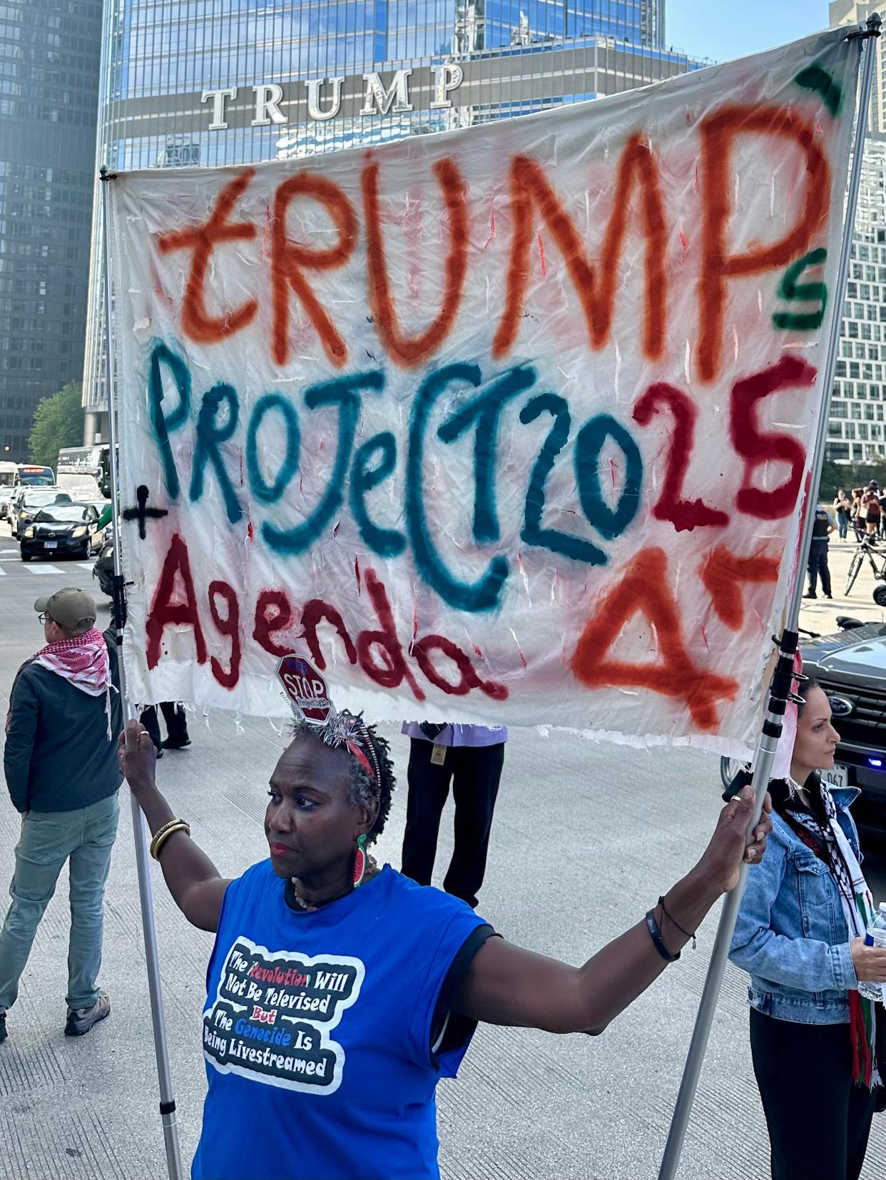 Nadine Seiler, 59, traveled to Chicago to join Sunday’s protest march. “I came in solidarity with their cause but I also wanted to bring my message about Trump and Project 2025,” she said. The march started within sight of a Trump-branded building in downtown Chicago.