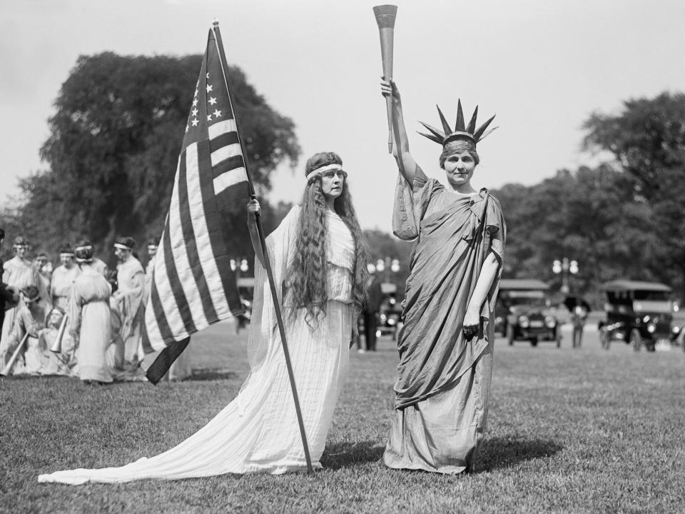 Women are dressed up in Washington, DC, on July 4, 1919, including a woman dressed as the Statue of Liberty.