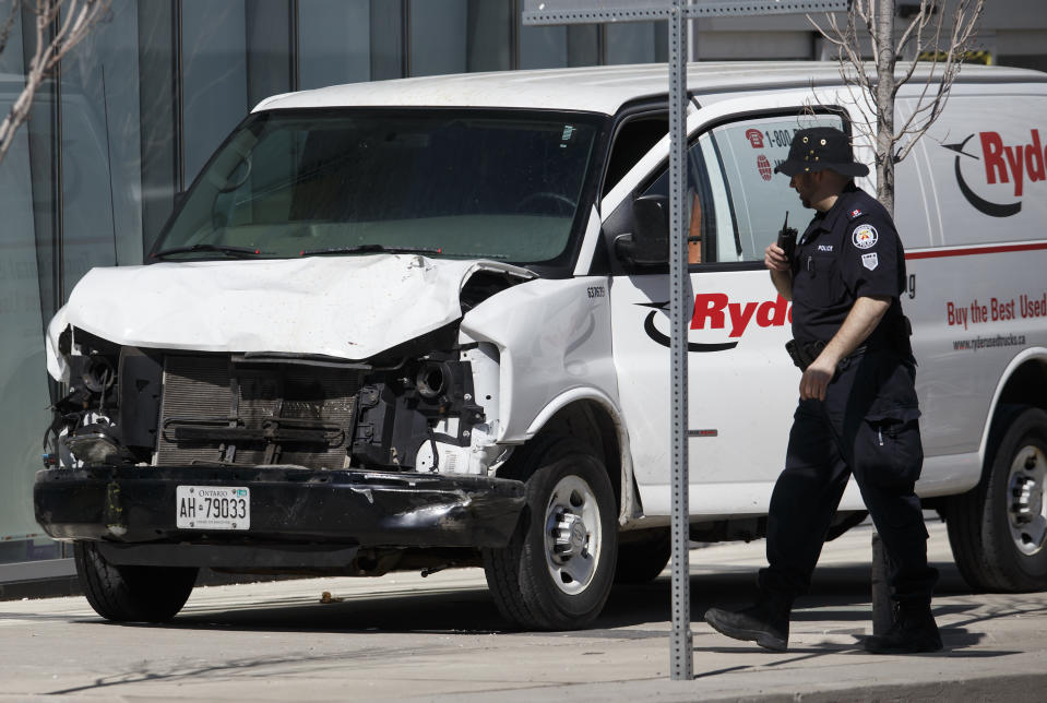 <p>Police inspect a van suspected of being involved in a collision injuring at least eight people at Yonge St. and Finch Ave. on April 23, 2018 in Toronto, Canada. A suspect is in custody after a white van collided with multiple pedestrians. (Photo: Cole Burston/Getty Images) </p>