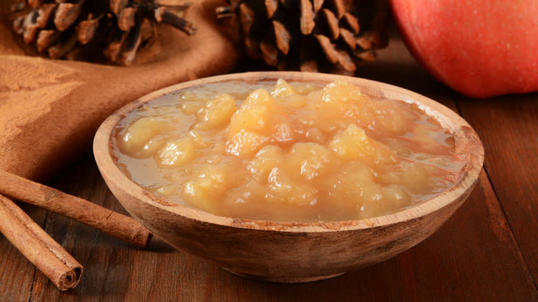 chunky applesauce beside cinnamon sticks