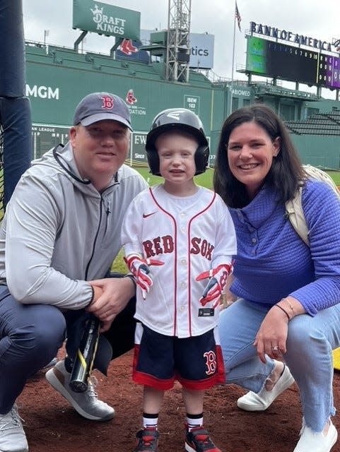 From left to right: Frank, Kieran and Joanne Whall pose at Fenway Park where Kieran got some batting practice.