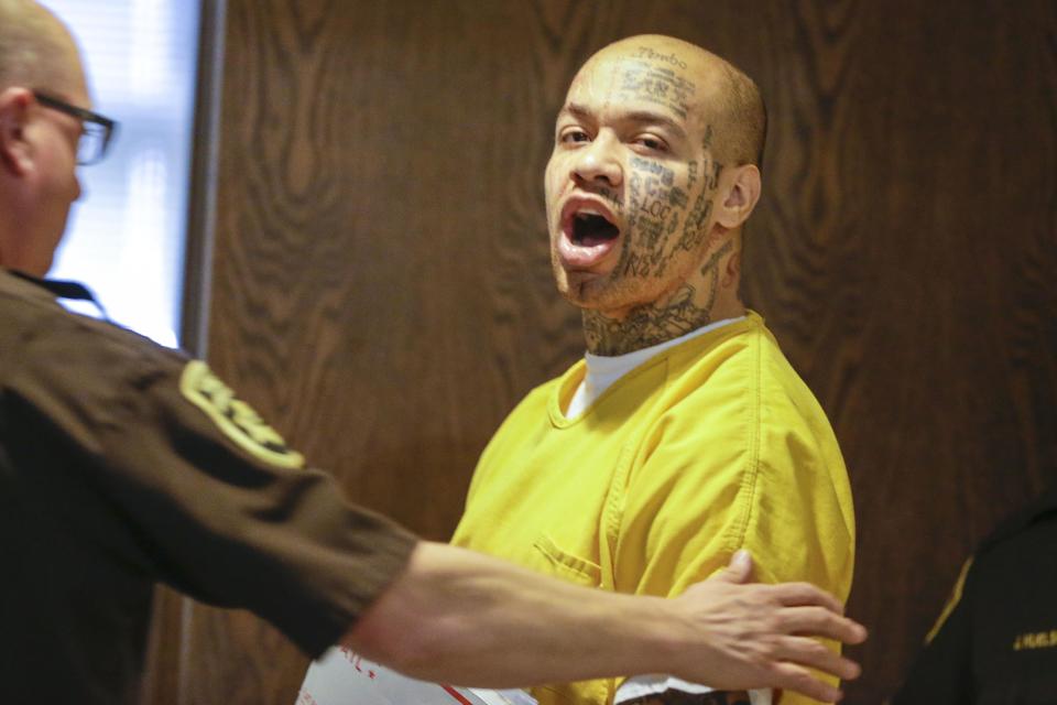 Nikko Jenkins, charged with four counts of first-degree murder in the slayings of four Omaha people last summer, is led to court by a Douglas County deputy in Omaha, Neb., Wednesday, April 16, 2014. Jenkins was found guilty on all charges. (AP Photo/Nati Harnik)