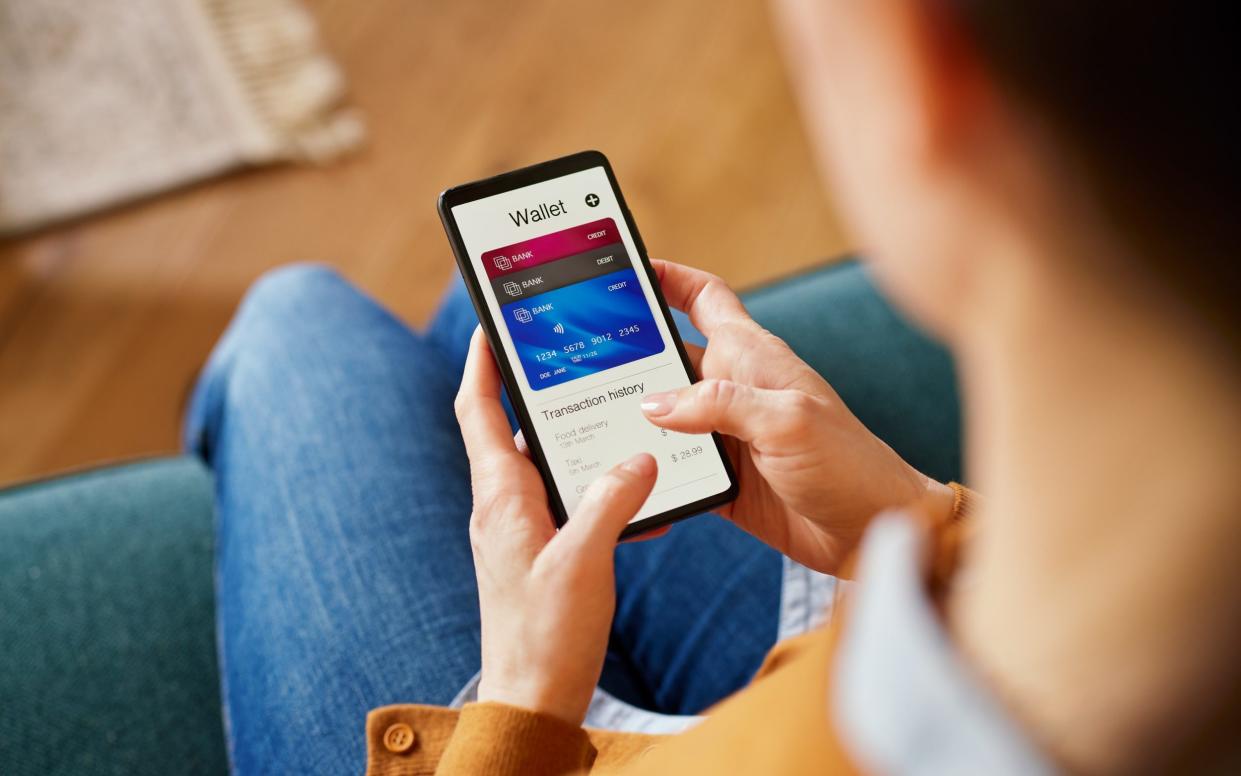 Close up of woman hand using smartphone to check the balance of her digital online wallet