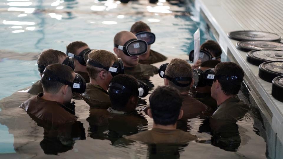 Special Warfare Training Wing trainees discuss a plan of action before a water confidence exercise. (Nicholas J. De La Pena/Air Force)