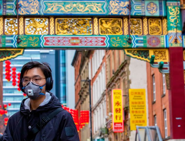 A passerby wearing a face mask in Manchester's Chinatown 