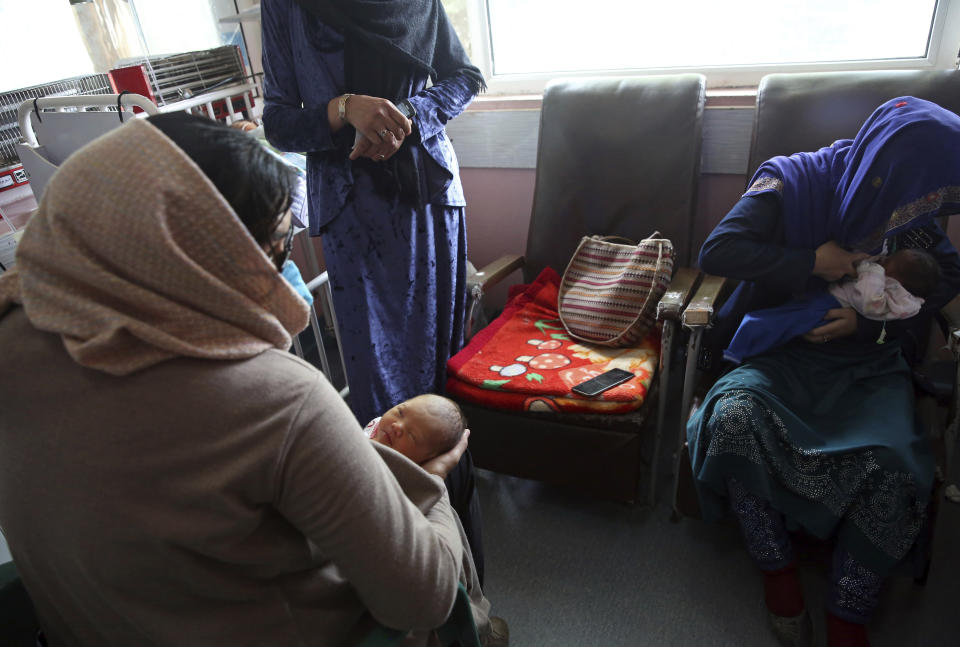 A mother, right, breastfeeds her two-day-old baby at the Ataturk Children's Hospital, a day after they were rescued from a deadly attack on another maternity hospital, in Kabul, Afghanistan, Wednesday, May 13, 2020. Militants stormed the Barchi National Maternity Hospital in the western part of Kabul on Tuesday, setting off an hours-long shootout with the police and killing tens of people, including two newborn babies, their mothers and an unspecified number of nurses, Afghan officials said. (AP Photo/Rahmat Gul)