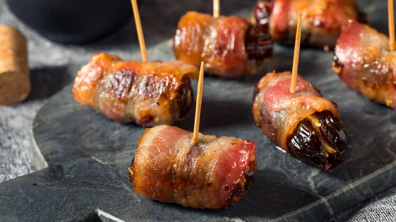 Bacon-wrapped dates on plate