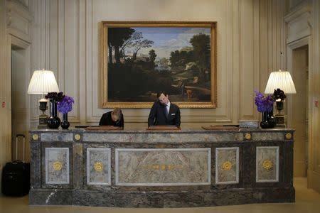 Employees are seen at work at the luxury hotel Four Seasons George V, in Paris, France July 30, 2015. Nowhere in the world has more accommodation available on Airbnb than Paris. REUTERS/Stephane Mahe