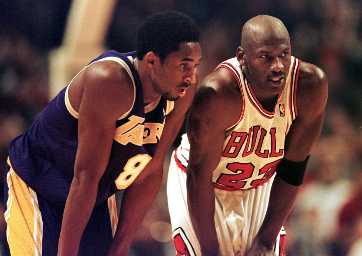 Kobe Bryant (left) and Michael Jordan talk during a Lakers-Bulls game.