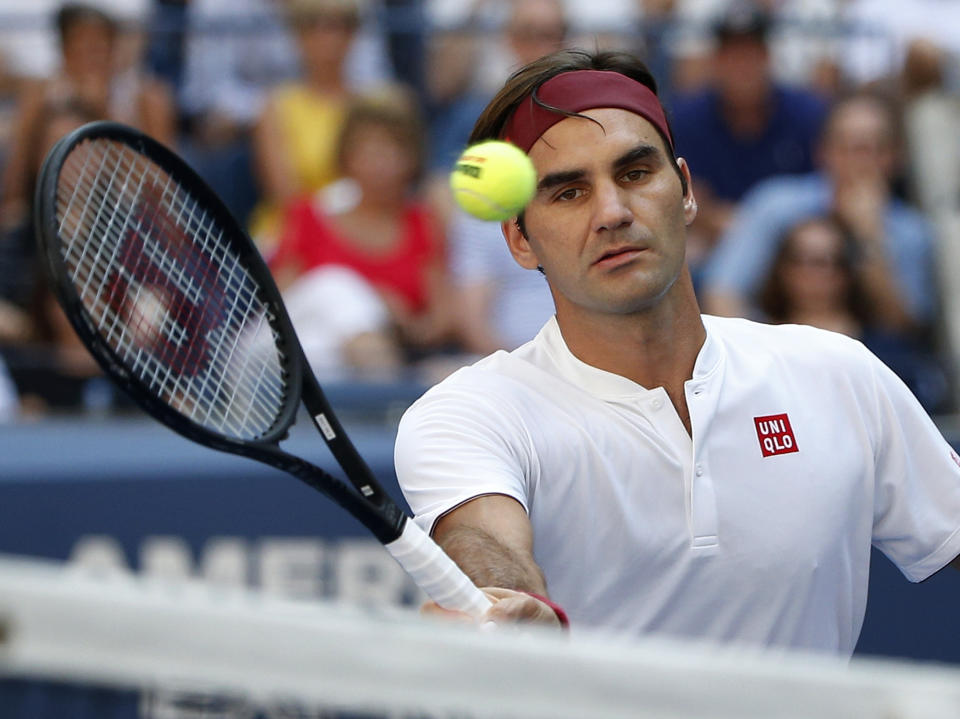 Roger Federer, of Switzerland, returns a shot to Nick Kyrgios, of Australia, during the third round of the U.S. Open tennis tournament, Saturday, Sept. 1, 2018, in New York. (AP Photo/Jason DeCrow)