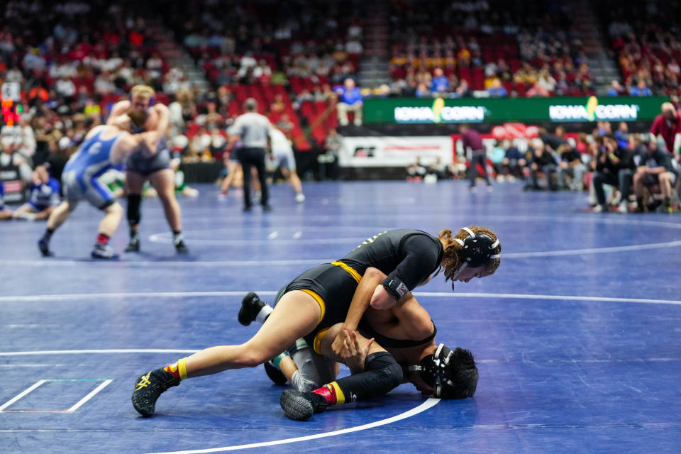 Sigourney-Keota’s Reanah Utterback, top, wrestles Clayton Ridge’s Erik Flores at 106 pounds during the second round of the Class 1A of the Iowa high school state wrestling tournament at Wells Fargo Arena in Des Moines on Wednesday, Feb. 15, 2023.