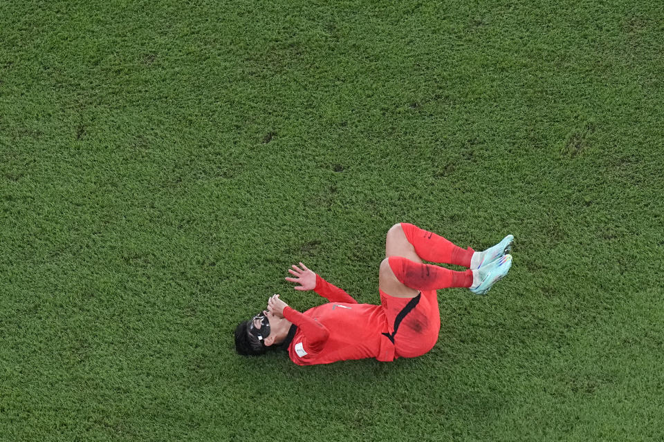 South Korea's Son Heung-min reacts on the pitch after a tackle during the World Cup round of 16 soccer match between Brazil and South Korea, at the Education City Stadium in Al Rayyan, Qatar, Monday, Dec. 5, 2022. (AP Photo/Pavel Golovkin)