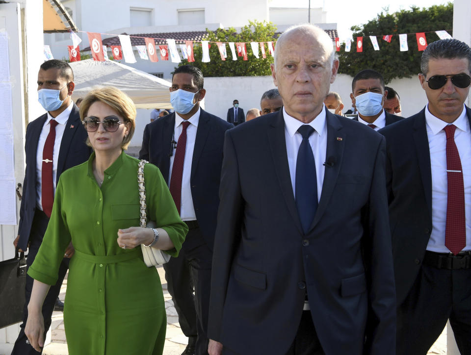 In this photo provided by the Tunisian Presidency, Tunisian President Kais Saied and his wife Ichraf Chebil leave the polling station after they cast their votes in Tunis, Tunisia, Monday, July 25, 2022. Tunisians head to the polls Monday to vote on a new constitution. (Slim Abid/Tunisian Presidency via AP)
