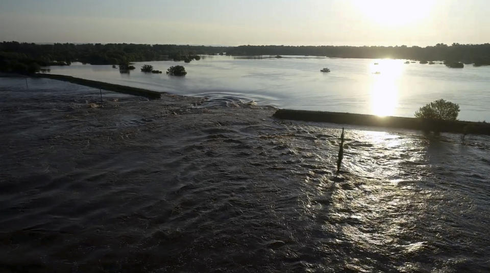 In this aerial image provided by Yell County Sheriff's Department water rushes through the levee along the Arkansas River in Dardanelle, Ark., on Friday, May 31, 2019. Officials say the levee breached early Friday at Dardanelle, about 60 miles northwest of Little Rock. (Yell County Sheriff's Department via AP)