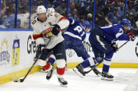 Florida Panthers right wing Patric Hornqvist (70) carries the puck ahead of Tampa Bay Lightning defenseman Victor Hedman (77) and defenseman Erik Cernak (81) during the first period in Game 4 of an NHL hockey second-round playoff series Monday, May 23, 2022, in Tampa, Fla. (AP Photo/Chris O'Meara)