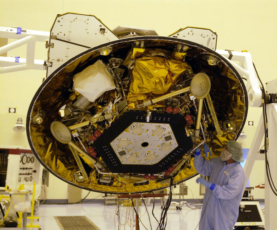 FILE - In this June 26, 2007 file photo, a technician makes checks on NASA's Phoenix Mars Lander in the Payload Hazardous Servicing Facility at the Kennedy Space Center in Cape Canaveral, Fla. (AP Photo/Peter Cosgrove, File)