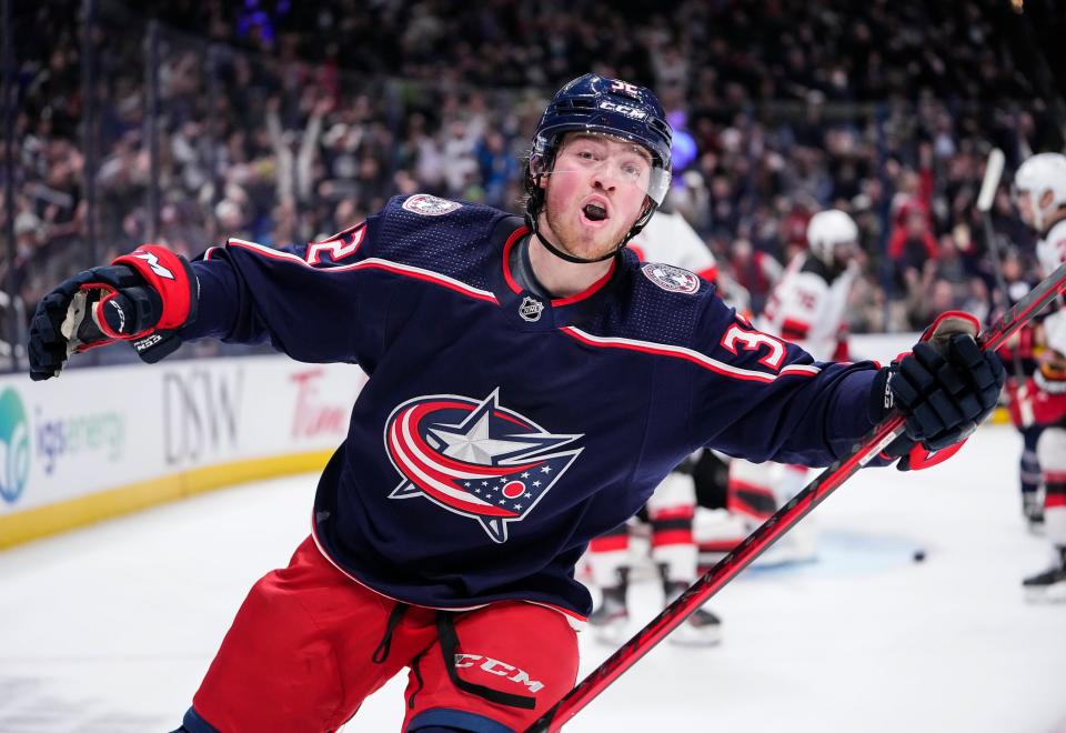 Blue Jackets defenseman Jake Christiansen celebrates scoring his first NHL goal during the first period of the hockey game against the Devils on March 1, 2022.