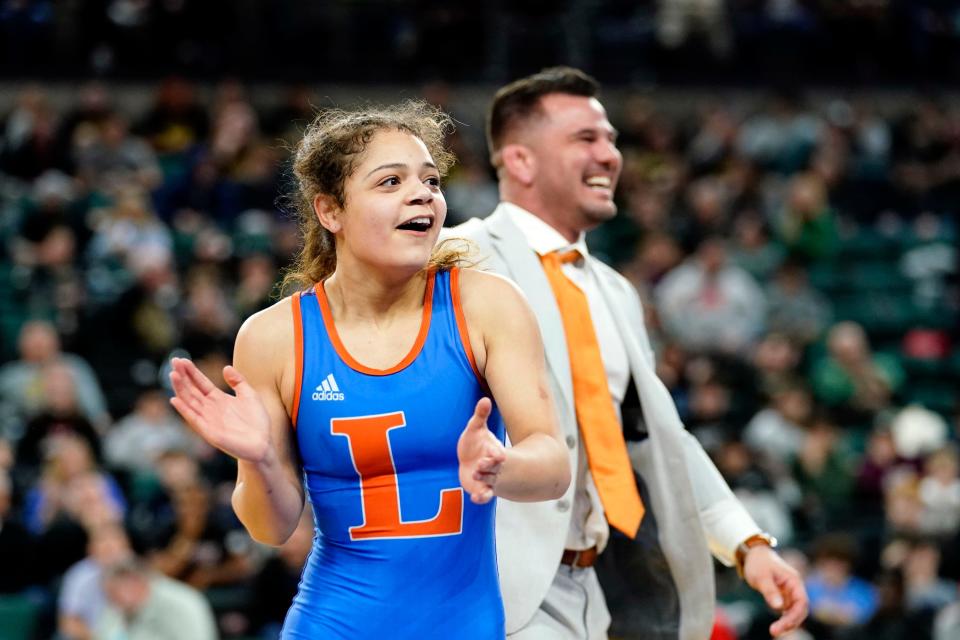 Leeana Mercado of Lodi celebrates the win with head coach Dale Fava for the 107-pound state wrestling final at Boardwalk Hall in Atlantic City on Saturday, March 4, 2023.