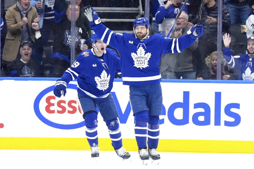 Toronto Maple Leafs defenseman Timothy Liljegren (37) celebrates his goal alongside teammate Calle Jarnkrok (19) during the first period of an NHL hockey game against the Colorado Avalanche, Saturday, Jan. 13, 2024 in Toronto. (Chris Young/The Canadian Press via AP)