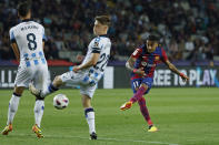 Barcelona's Raphinha shoots on goal during a Spanish La Liga soccer match between Barcelona and Real Sociedad at the Olimpic Lluis Companys stadium in Barcelona, Spain, Monday, May 13, 2024. (AP Photo/Joan Monfort)