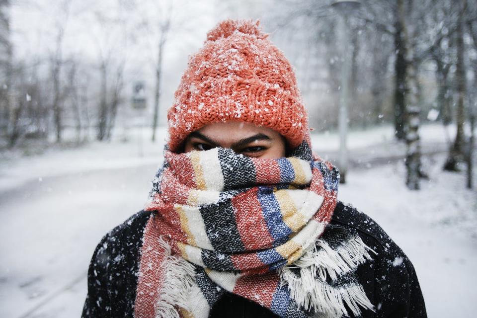 A young woman walking and enjoying at the Rembrandt Park during snowfall in Amsterdam,Netherlands.