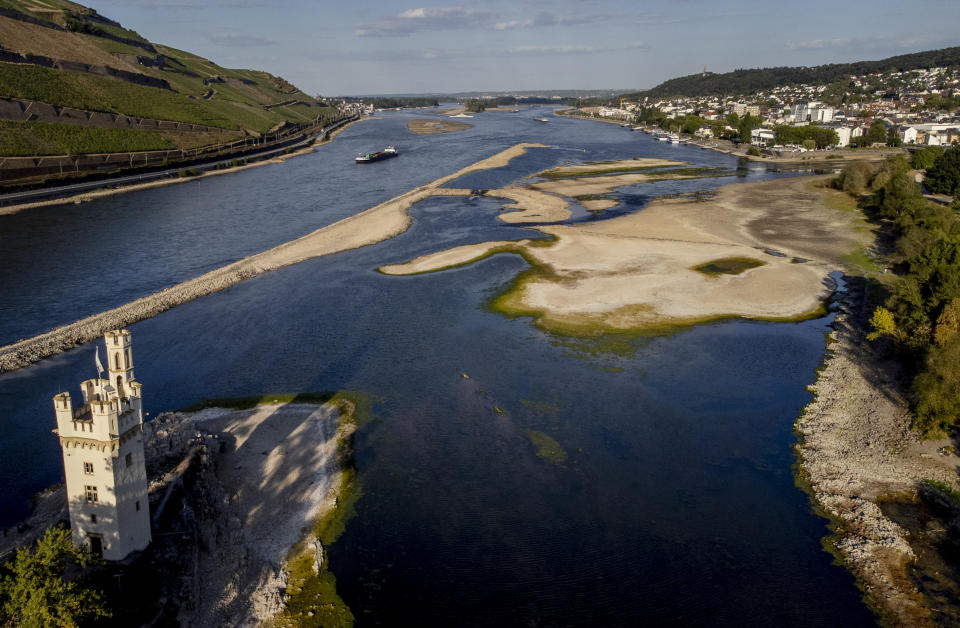 The "Maeuseturm" (mice tower) is pictured in the middle of the river Rhine in Bingen, Germany, Friday, Aug. 12, 2022. The Rhine carries low water after a long drought period. (AP Photo/Michael Probst)