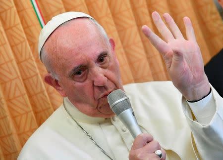 Pope Francis gestures as he speaks to journalists on his flight back to Rome following a visit in Georgia and Azerbaijan, October 2, 2016. REUTERS/Luca Zennaro/Pool