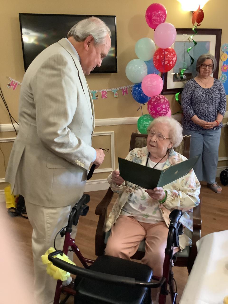 Oak Ridge Mayor Warren Gooch presents a proclamation to Tiddle Thomas at her 100th birthday celebration.